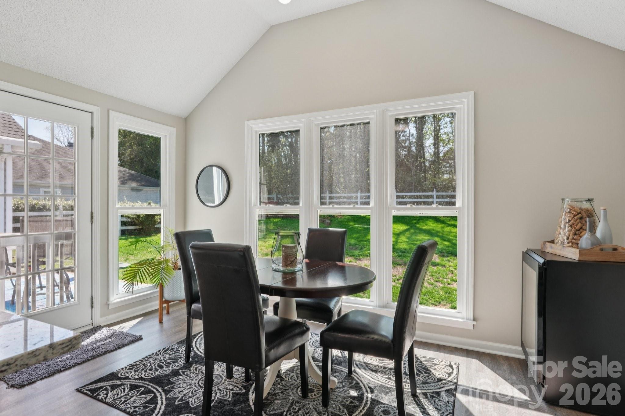 3661 Lake Spring Avenue Northwest Concord, NC 28027 - Photo 12 of 42 a dining room with furniture a rug and a floor to ceiling window