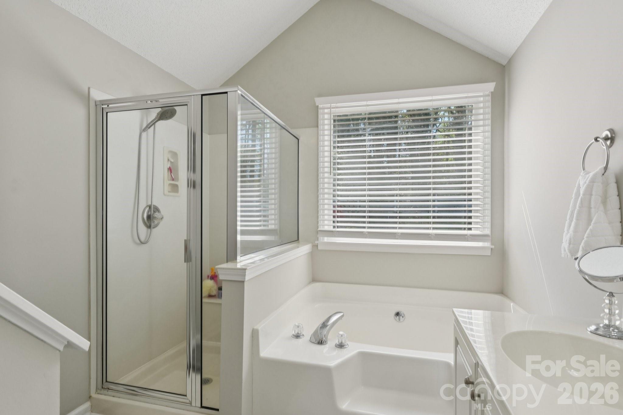 3661 Lake Spring Avenue Northwest Concord, NC 28027 - Photo 22 of 42 a bathroom with a bathtub shower and a toilet