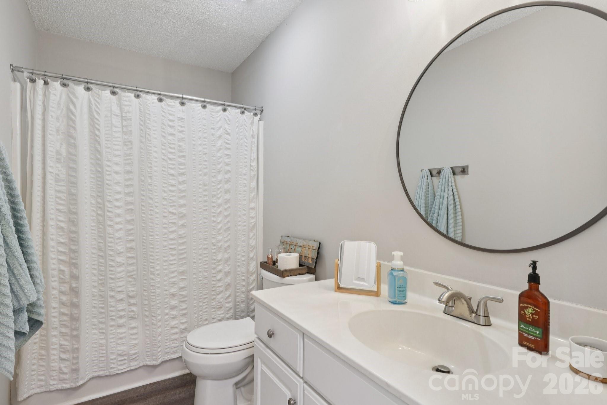 3661 Lake Spring Avenue Northwest Concord, NC 28027 - Photo 26 of 42 a bathroom with a sink mirror and toilet