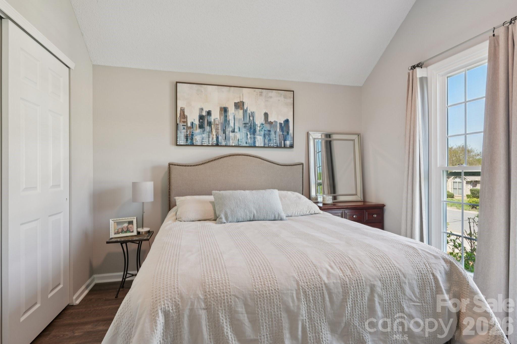 3661 Lake Spring Avenue Northwest Concord, NC 28027 - Photo 33 of 42 a bedroom with a bed and a painting on the wall