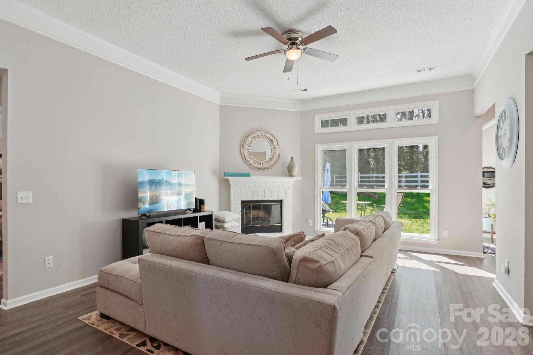 3661 Lake Spring Avenue Northwest Concord, NC 28027 - Photo 7 of 42 a living room with furniture a fireplace and a large window