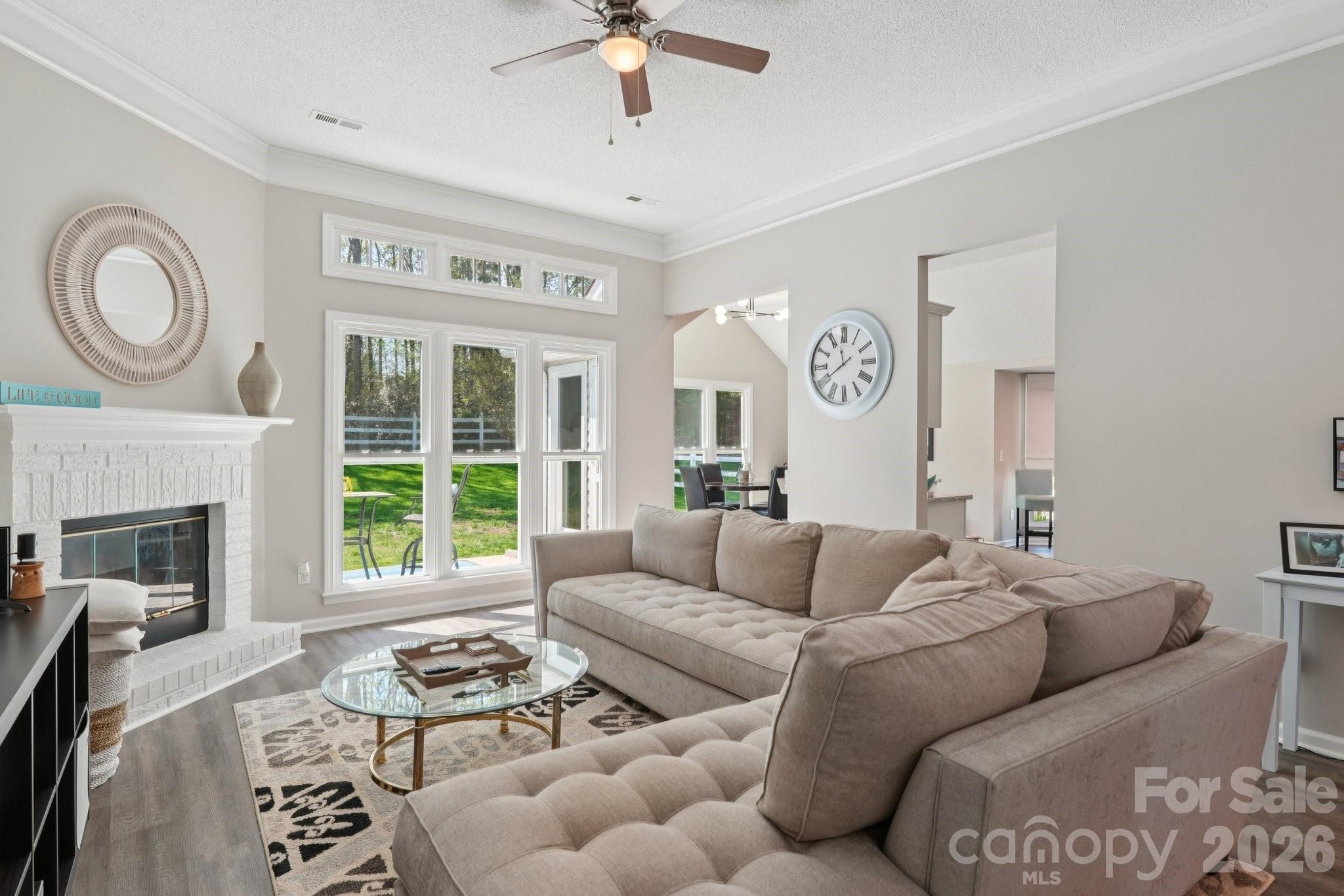 3661 Lake Spring Avenue Northwest Concord, NC 28027 - Photo 8 of 42 a living room with furniture a large window and a fireplace
