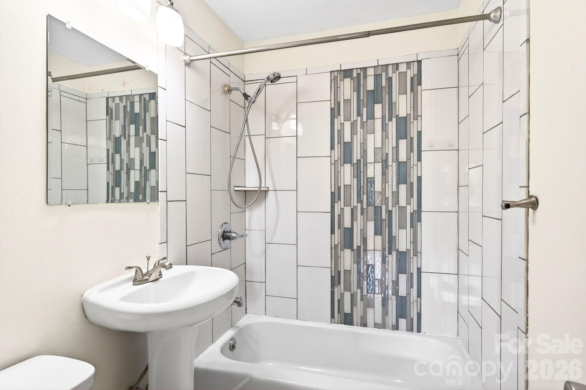 34 Wolfe Cove Road Asheville, NC 28804 - Photo 15 of 42 a bathroom with a sink a toilet and shower