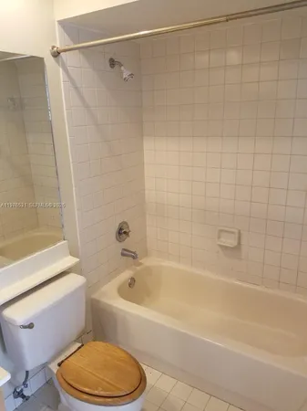 a bathroom with a toilet and a bath tub