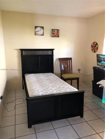 a bed sitting in a bedroom