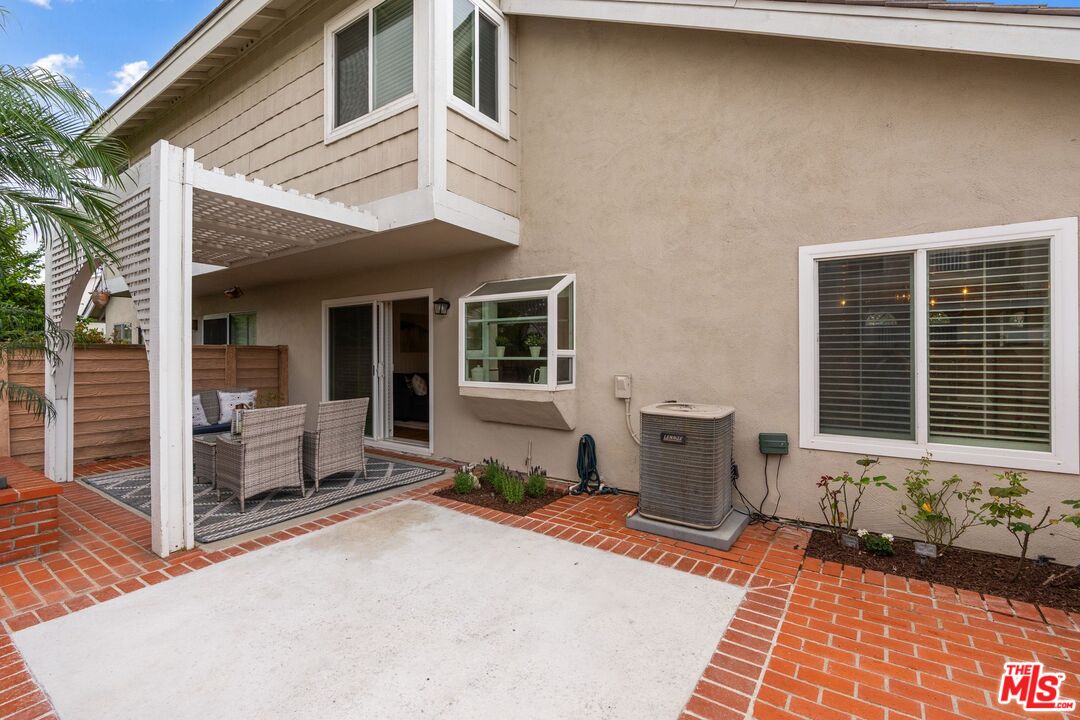 23 Cresthaven, Unit 51 Irvine, CA 92604 - Photo 16 of 24 a front view of a house with barbeque outdoor seating