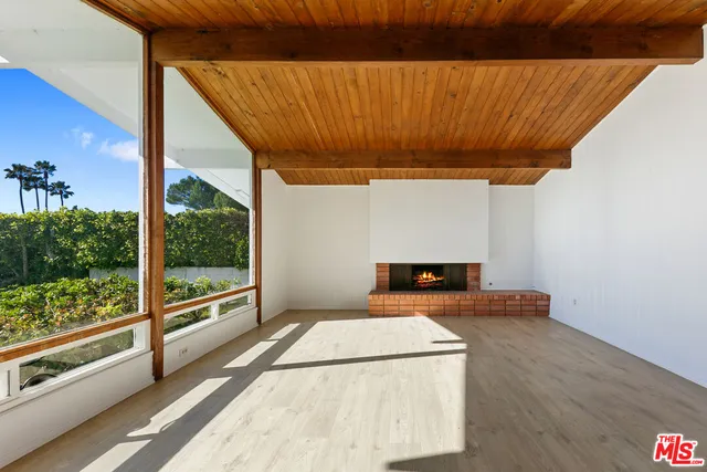 a view of a room with wooden floor and iron stairs
