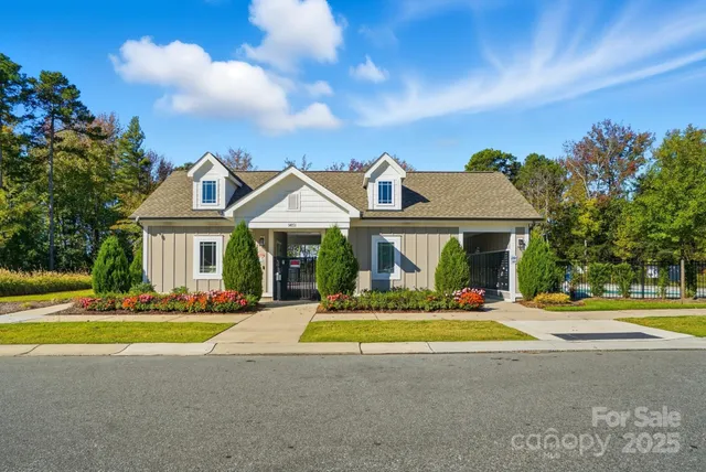 a front view of a house with swimming pool and porch