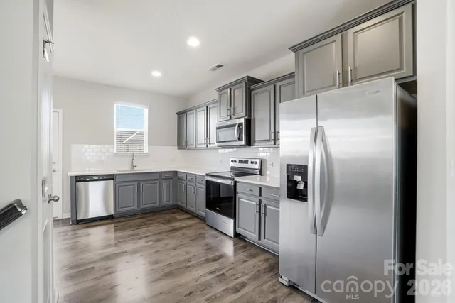 a kitchen with stainless steel appliances cabinets a sink and a counter top space