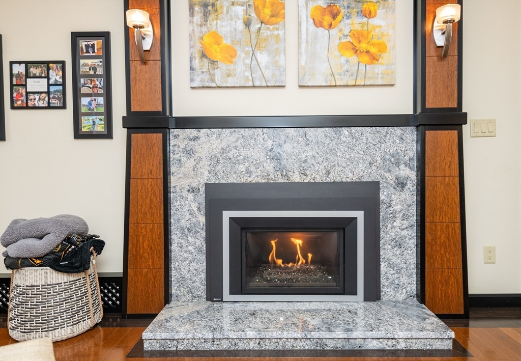 25 Ellen Road Stoneham, MA 02180 - Photo 9 of 41 a living room with fireplace and a wooden floor