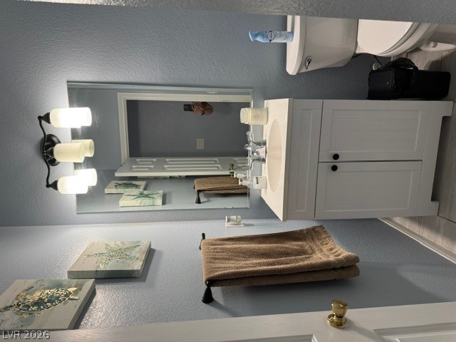 5171 Piazza Cavour Drive Las Vegas, NV 89156 - Photo 3 of 13 A clean, functional bathroom vanity with bright lighting and a contemporary mirror.