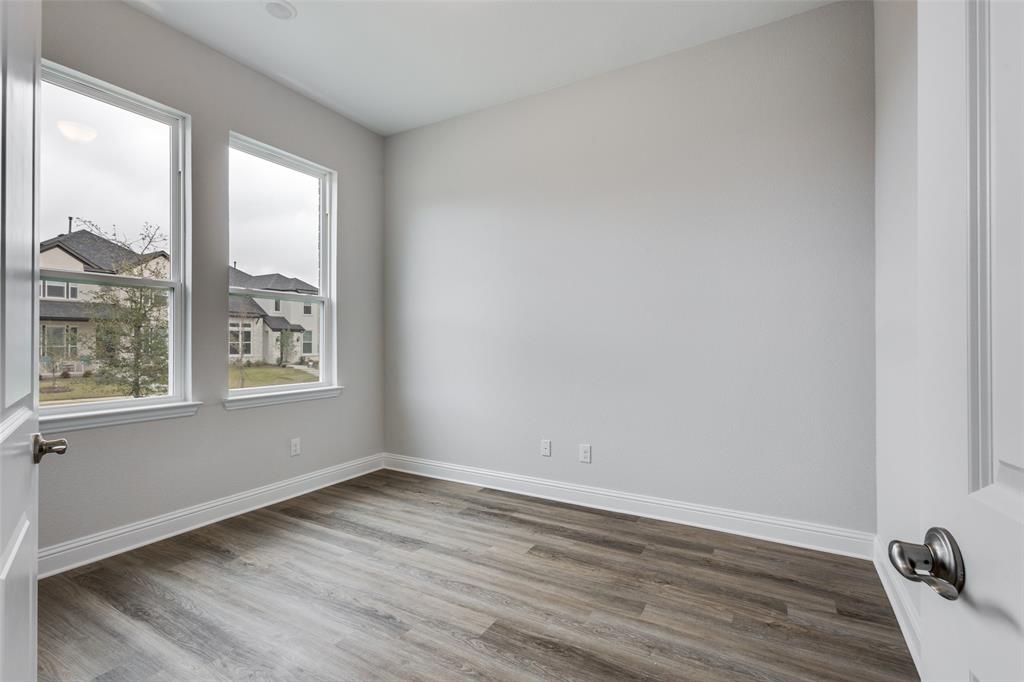 11764 Chartwell Court Frisco, TX 75035 - Photo 12 of 25 a view of an empty room with wooden floor and a window