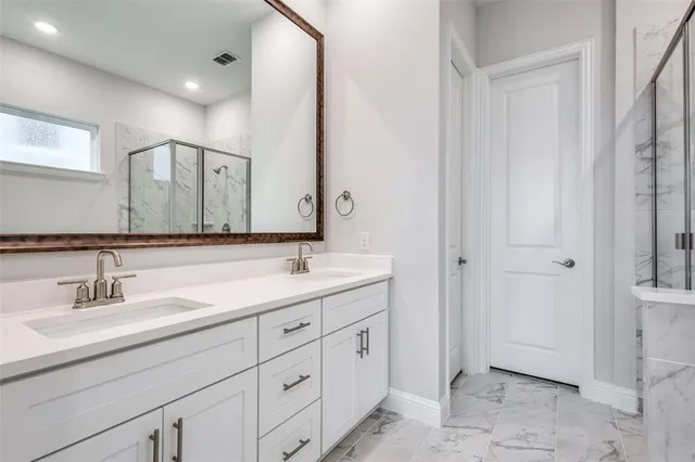 a bathroom with a white bath tub and shower