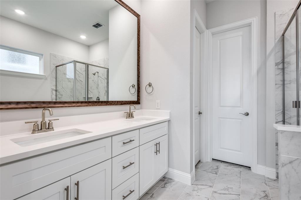11764 Chartwell Court Frisco, TX 75035 - Photo 14 of 25 a bathroom with a double vanity sink and mirror
