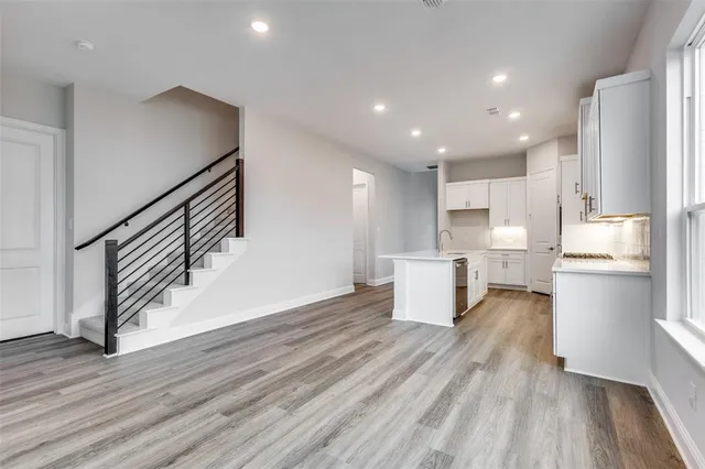 a view of kitchen with wooden floor and electronic appliances