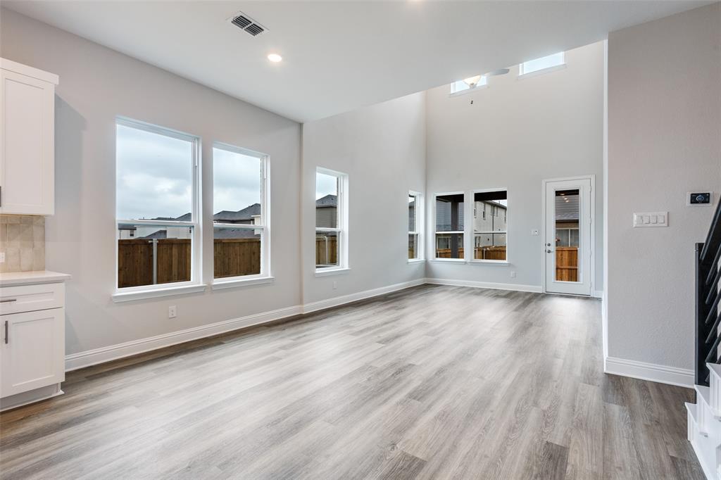 11764 Chartwell Court Frisco, TX 75035 - Photo 9 of 25 an empty room with wooden floor and windows