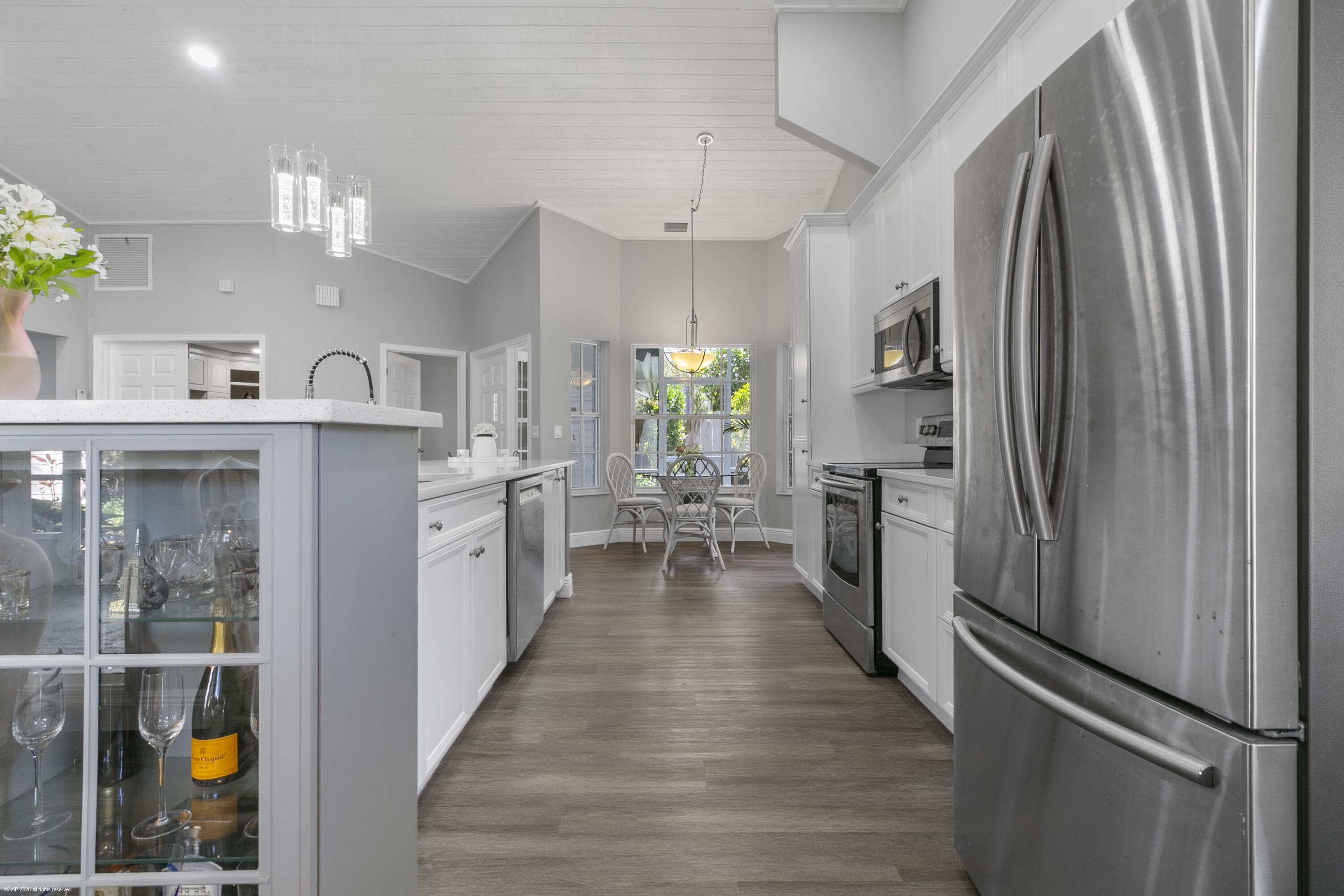 12635 Timber Ridge Circle Wellington, FL 33414 - Photo 12 of 33 a kitchen with counter top space and stainless steel appliances