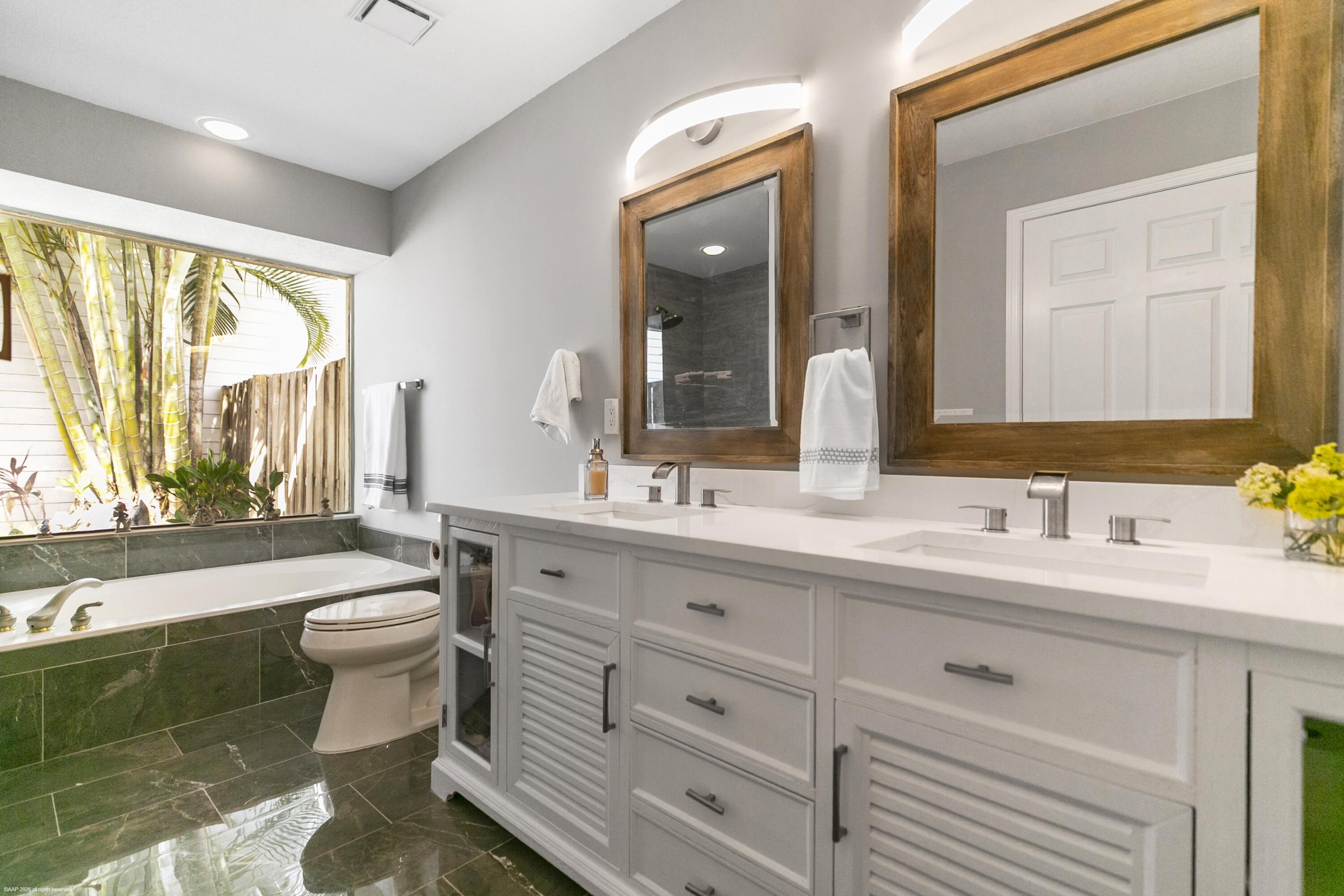 12635 Timber Ridge Circle Wellington, FL 33414 - Photo 16 of 33 a bathroom with a double vanity sink toilet and a mirror