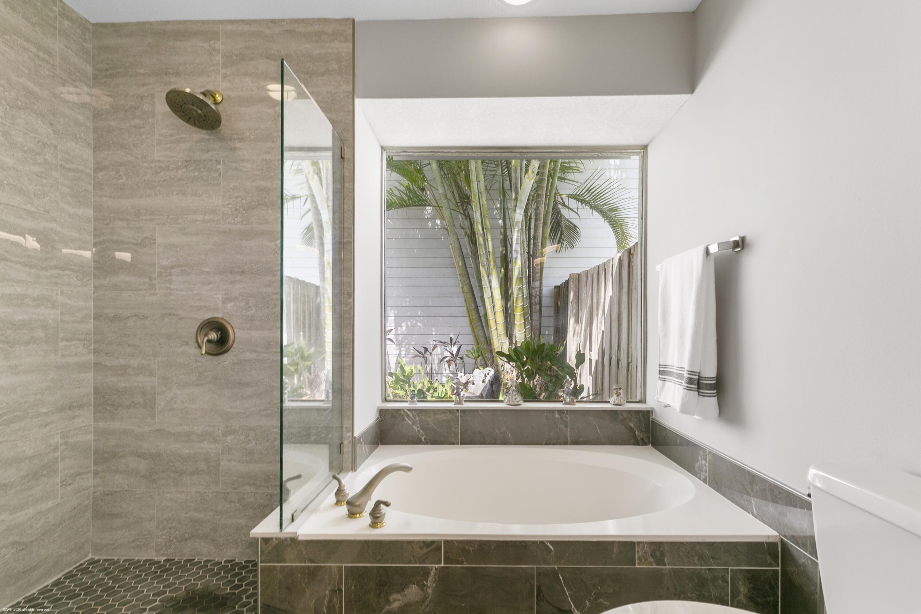 12635 Timber Ridge Circle Wellington, FL 33414 - Photo 17 of 33 a bath tub sitting in a bathroom next to a window