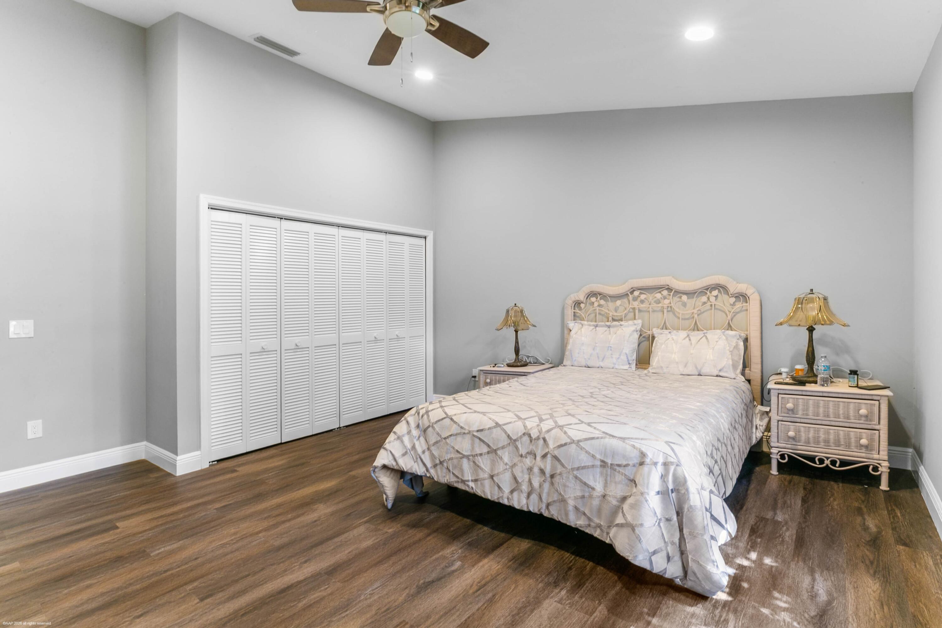 12635 Timber Ridge Circle Wellington, FL 33414 - Photo 18 of 33 a bedroom with a bed and a ceiling fan