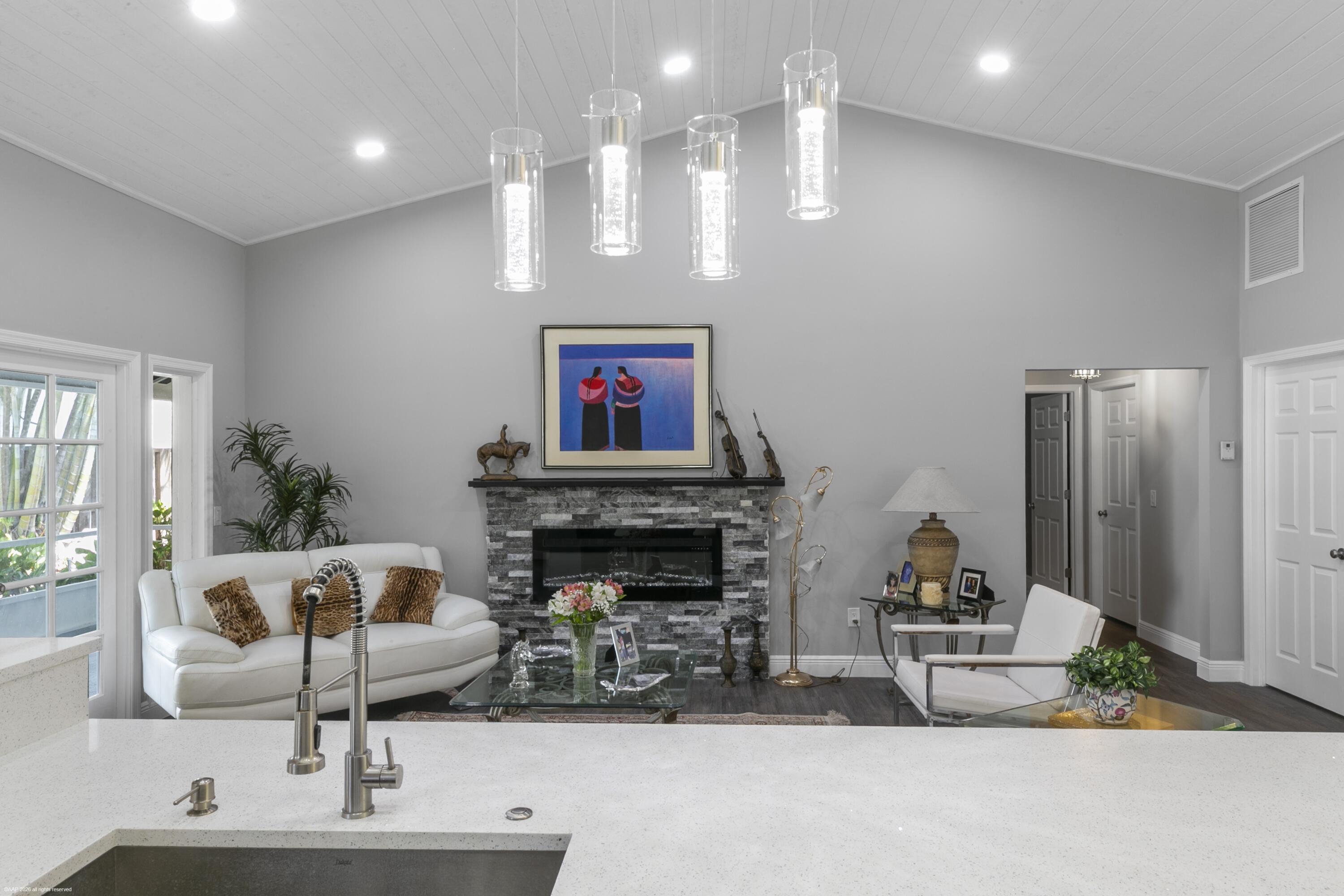 12635 Timber Ridge Circle Wellington, FL 33414 - Photo 8 of 33 a living room with furniture a fireplace and a potted plant