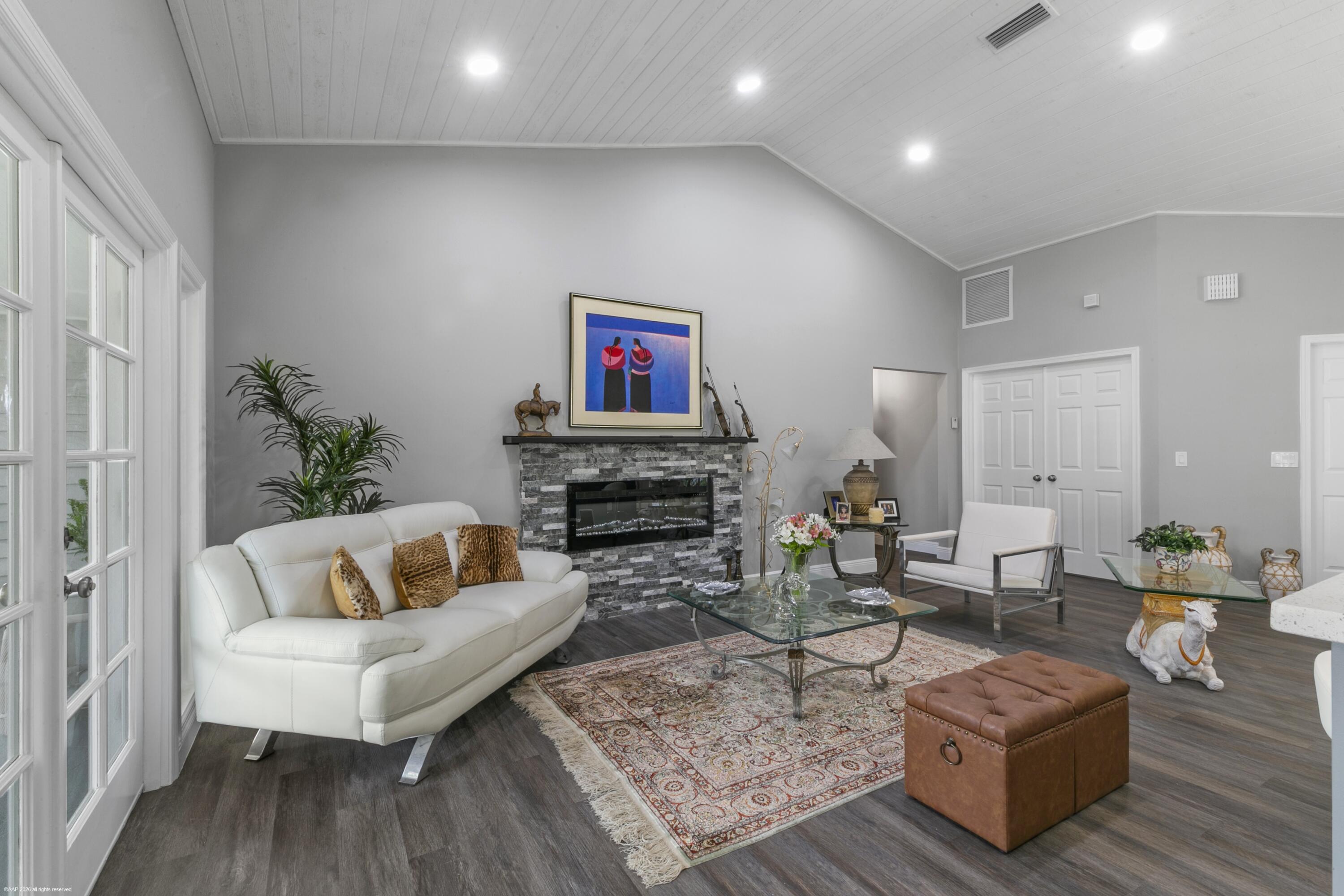 12635 Timber Ridge Circle Wellington, FL 33414 - Photo 9 of 33 a living room with fireplace furniture and a wooden floor