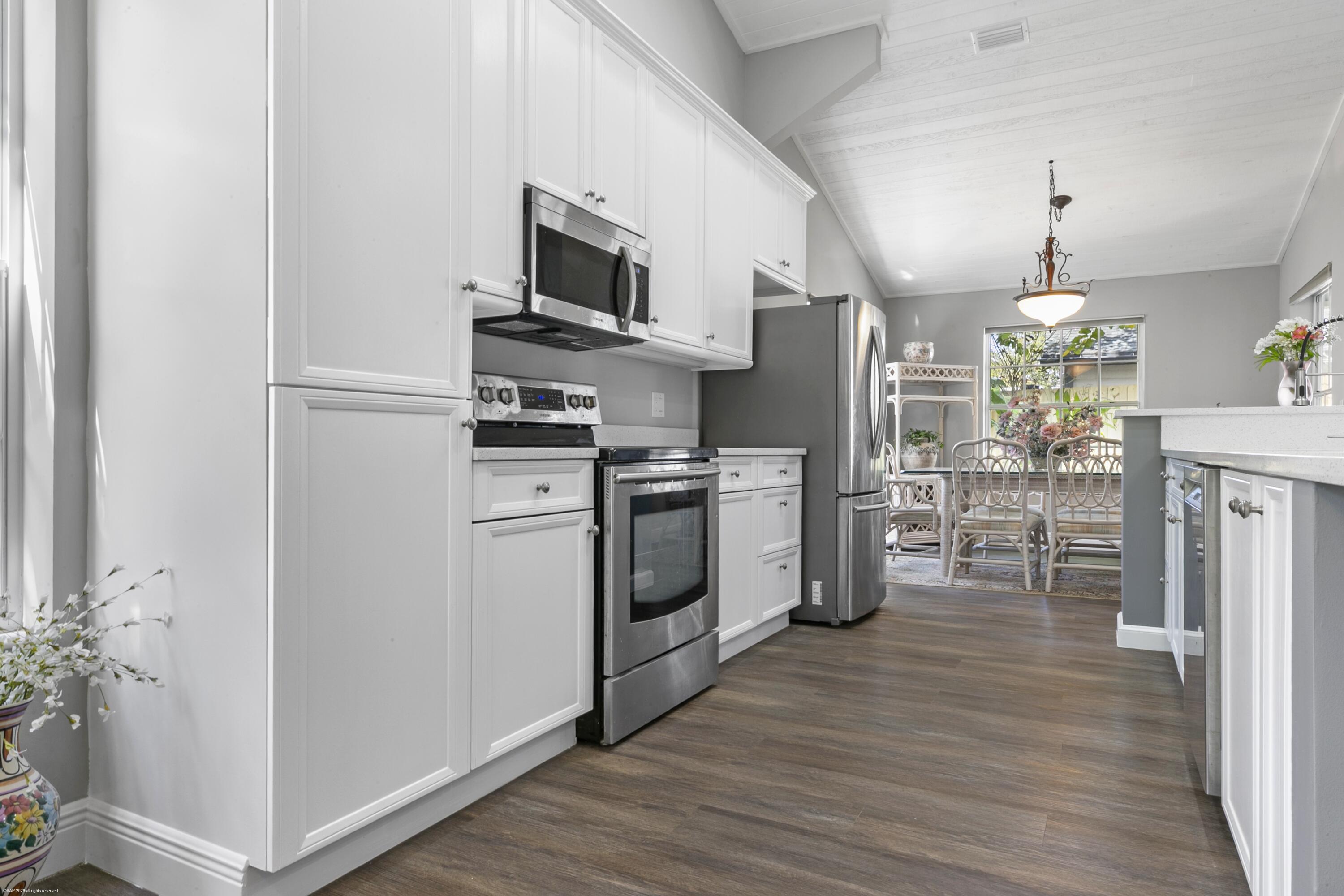 12635 Timber Ridge Circle Wellington, FL 33414 - Photo 10 of 33 a kitchen with stainless steel appliances a refrigerator stove and microwave