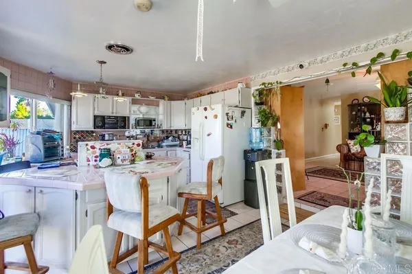 a kitchen with stainless steel appliances kitchen island granite countertop a refrigerator and microwave