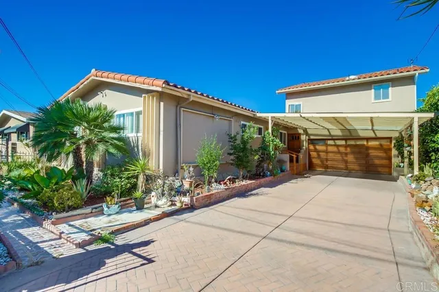 a backyard of a house with potted plants