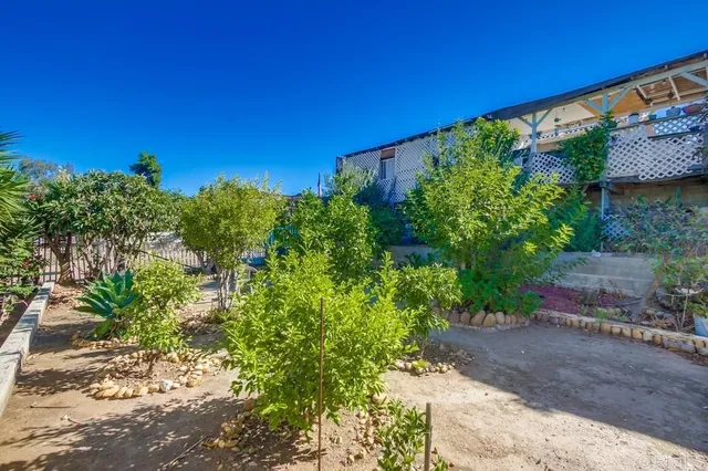 a view of a patio with table and chairs potted plants