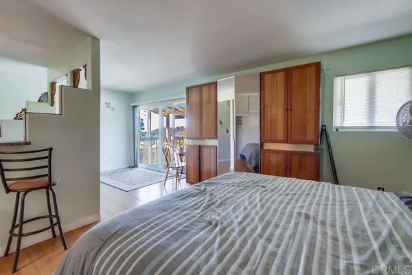 a bedroom with a bed and a dresser in it