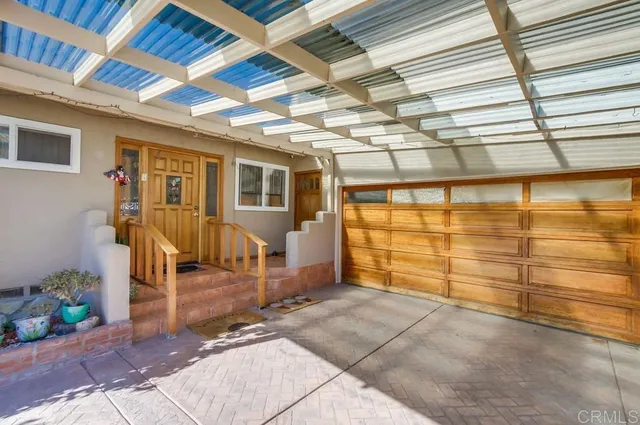 a view of a garage with wooden fence