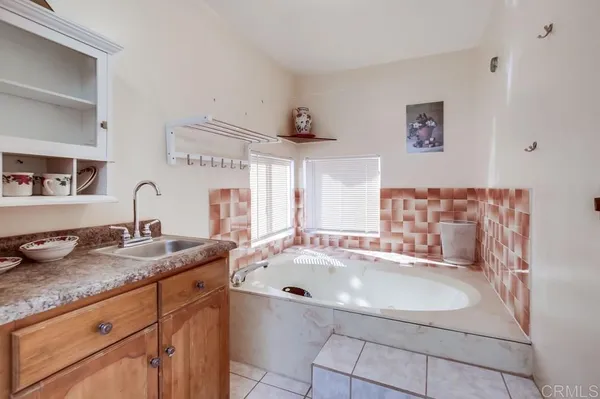 a bathroom with a sink a vanity and a mirror