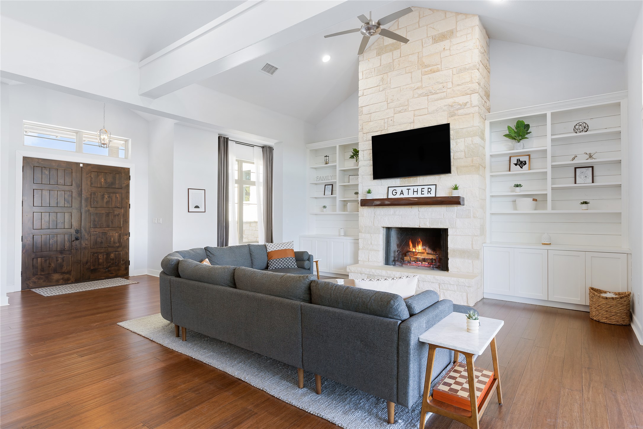 1821 Overland Stage Road Dripping Springs, TX 78620 - Photo 12 of 39 a living room with furniture a flat screen tv and a fireplace