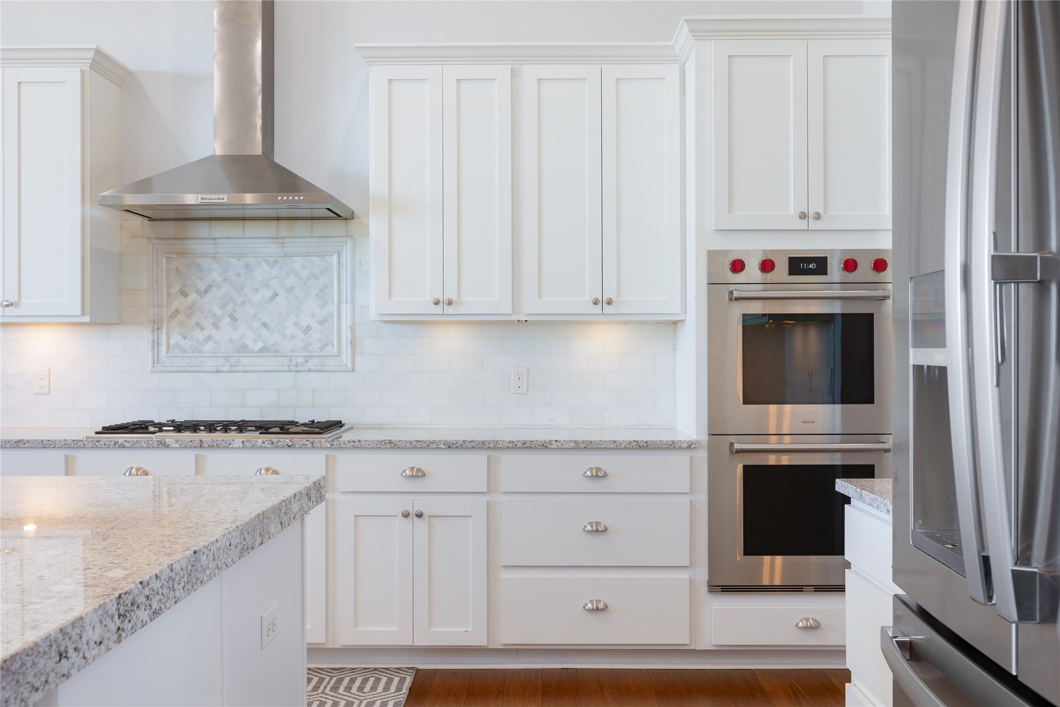 1821 Overland Stage Road Dripping Springs, TX 78620 - Photo 13 of 39 a kitchen with granite countertop white cabinets and a stove