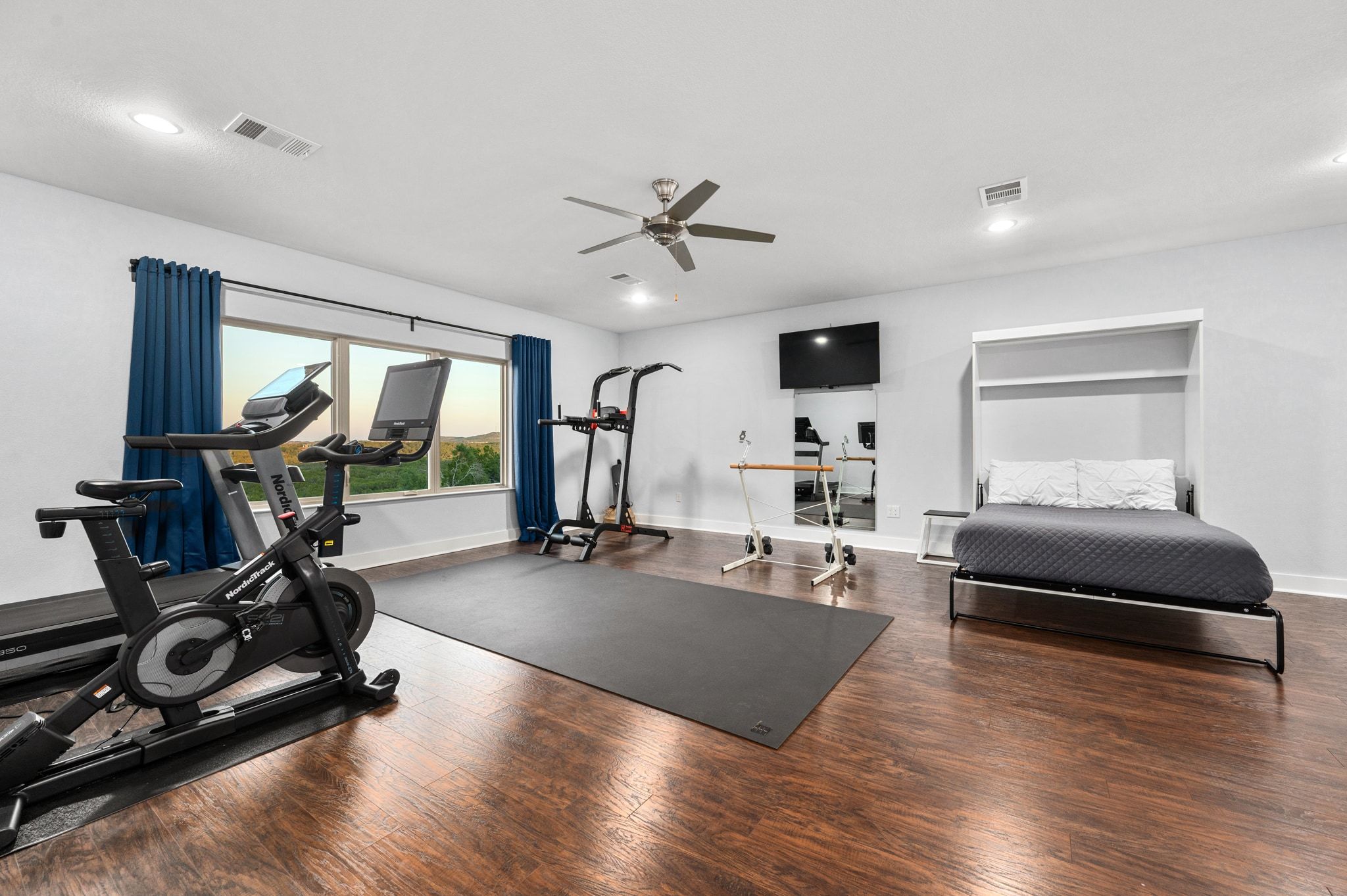 1821 Overland Stage Road Dripping Springs, TX 78620 - Photo 28 of 39 a living room with furniture gym equipment and a large window