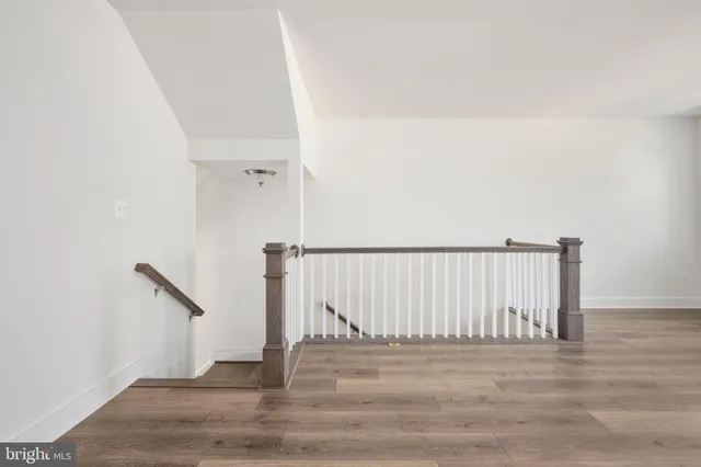 a kitchen with stainless steel appliances granite countertop a refrigerator a sink dishwasher a stove and a refrigerator with wooden floor