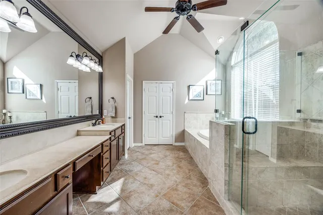 a large bathroom with a tub a sink and a mirror