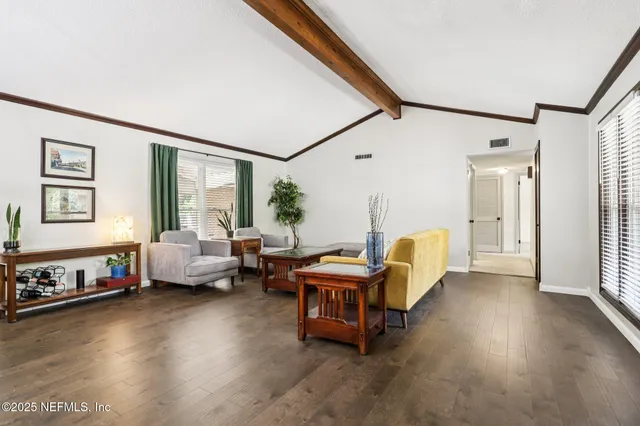 a view of a room with wooden floor and outdoor space