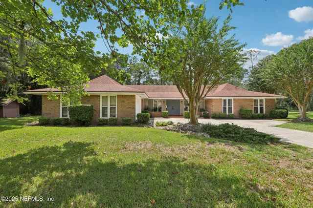 a view of a house with backyard sitting area and garden
