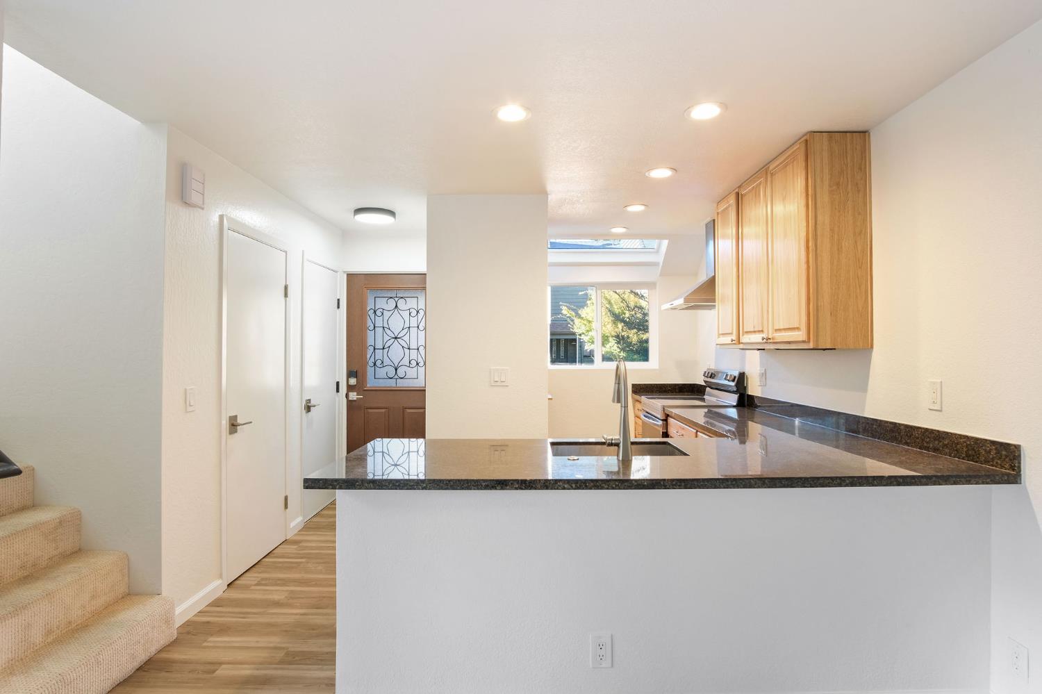 8667 Mariners Drive, Unit 53 Stockton, CA 95219 - Photo 6 of 24 a kitchen with granite countertop sink and cabinets