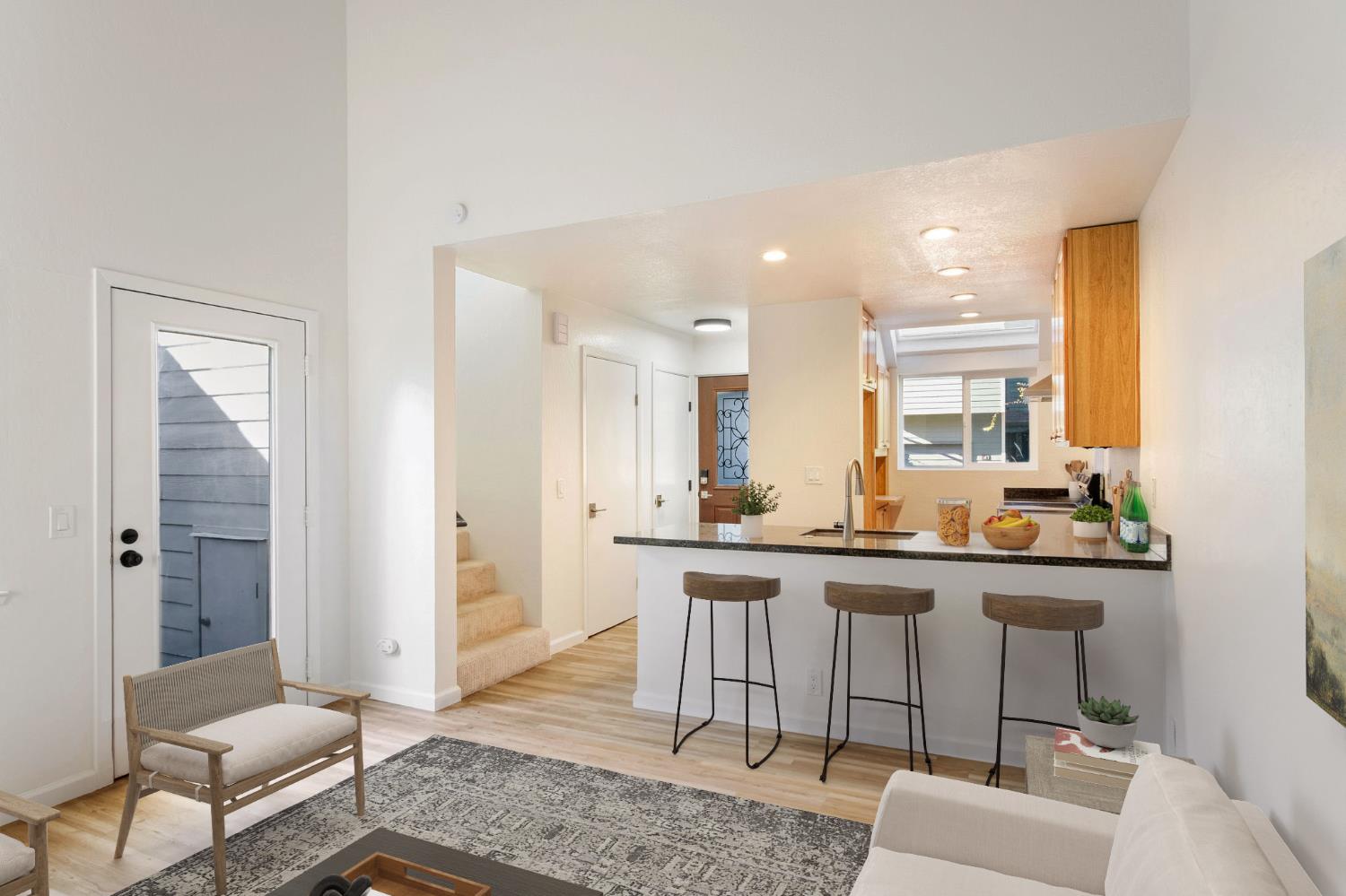 8667 Mariners Drive, Unit 53 Stockton, CA 95219 - Photo 7 of 24 a living room with furniture and a wooden floor