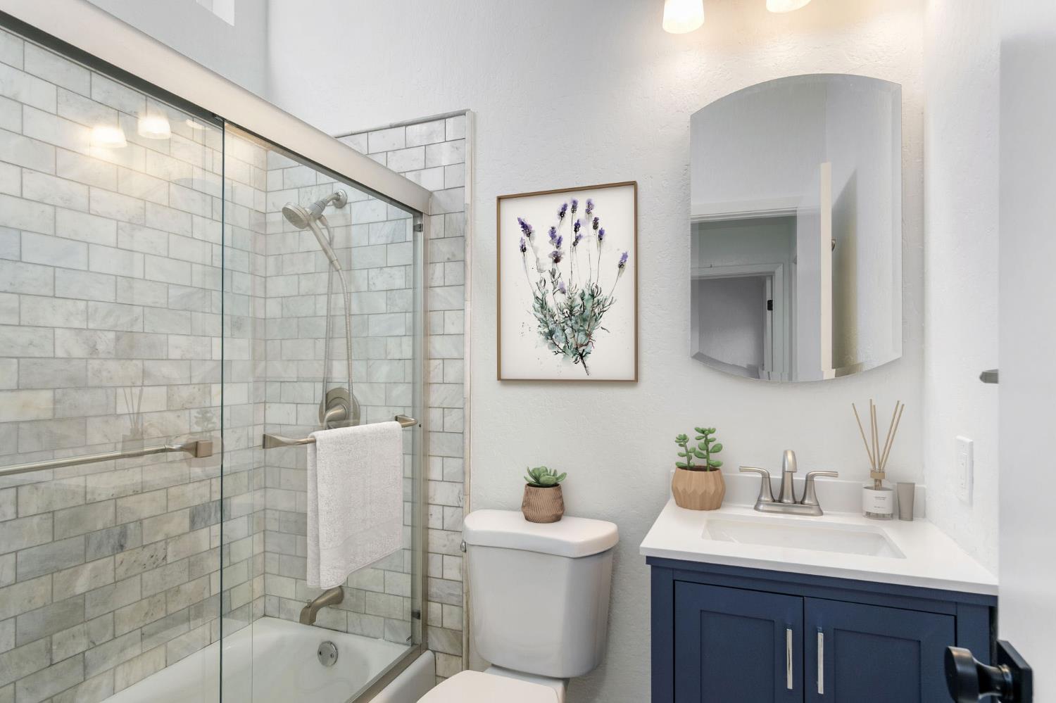 8667 Mariners Drive, Unit 53 Stockton, CA 95219 - Photo 8 of 24 a bathroom with a sink toilet and shower