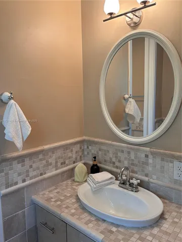 a white bath tub sitting next to a toilet