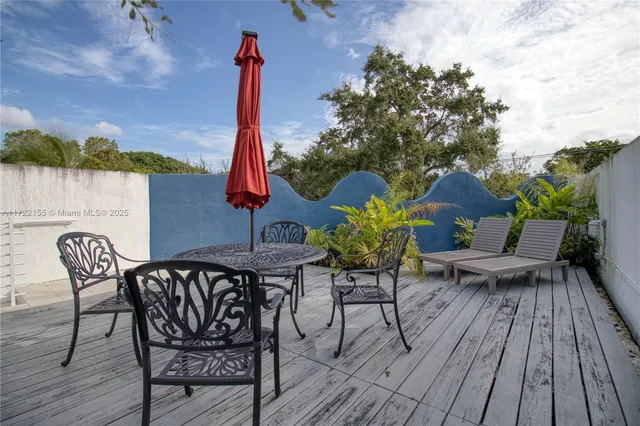 a view of a chairs and table on the deck