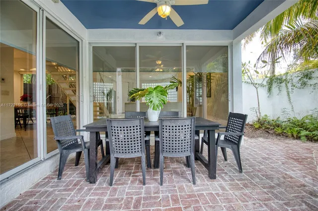 a dining room with furniture and a window