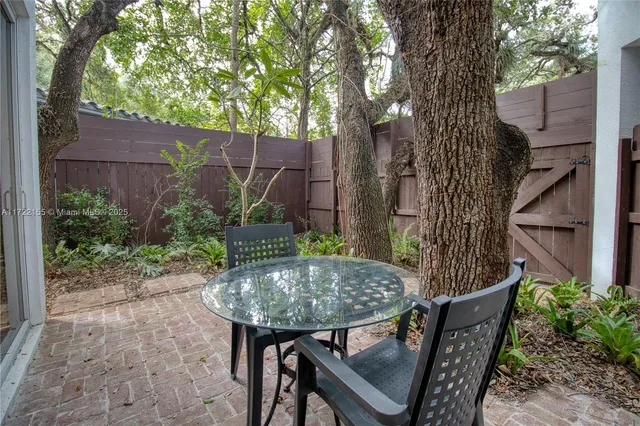 a front view of a house with a tree and plants