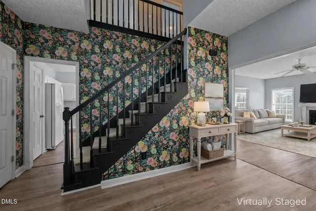 a view of entryway livingroom and hall with wooden floor
