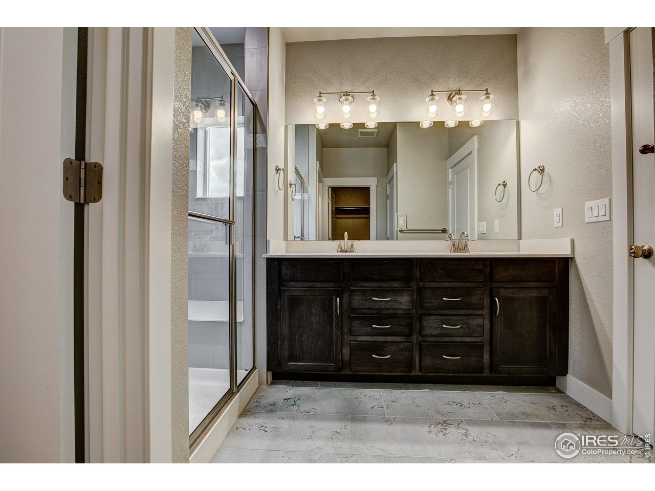 6227 Vernazza Way, Unit 2 Windsor, CO 80550 - Photo 12 of 35 a bathroom with a sink and a large mirror