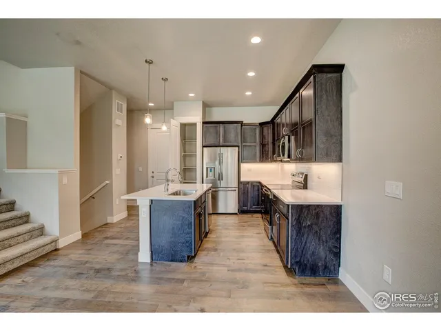 a living room with kitchen island furniture and a wooden floor